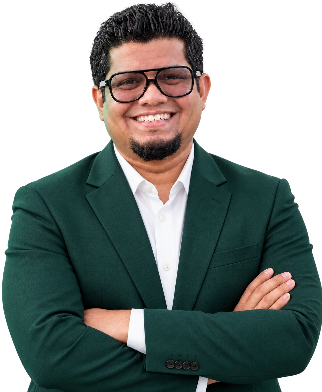 Alan DSouza in a green suit, arms crossed, smiling